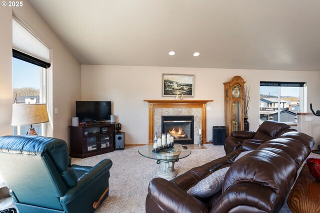 living area featuring carpet flooring, recessed lighting, and a premium fireplace