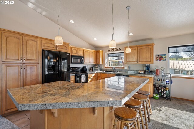 18989 NE Marine Dr Unit 44, Portland, OR 97230 - kitchen with black appliances, tile countertops, plenty of natural light, lofted ceiling, and a textured ceiling