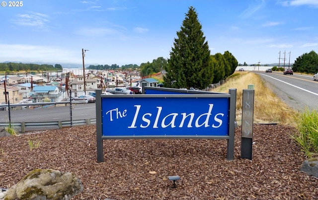 community sign featuring fence