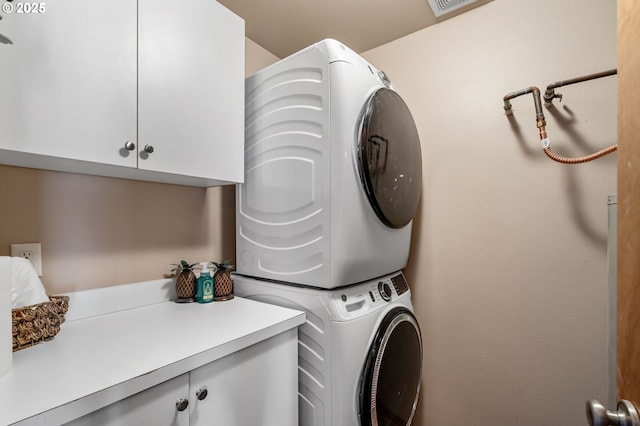 18989 NE Marine Dr Unit 44, Portland, OR 97230 - laundry room featuring stacked washer / drying machine and cabinet space