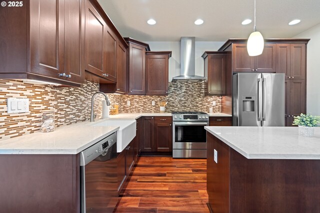 427 NW Garibaldi St, Hillsboro, OR 97124 - kitchen featuring appliances with stainless steel finishes, wall chimney exhaust hood, a sink, dark wood finished floors, and dark brown cabinets