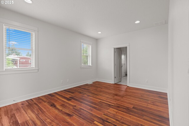 427 NW Garibaldi St, Hillsboro, OR 97124 - empty room with wood finished floors, baseboards, and recessed lighting