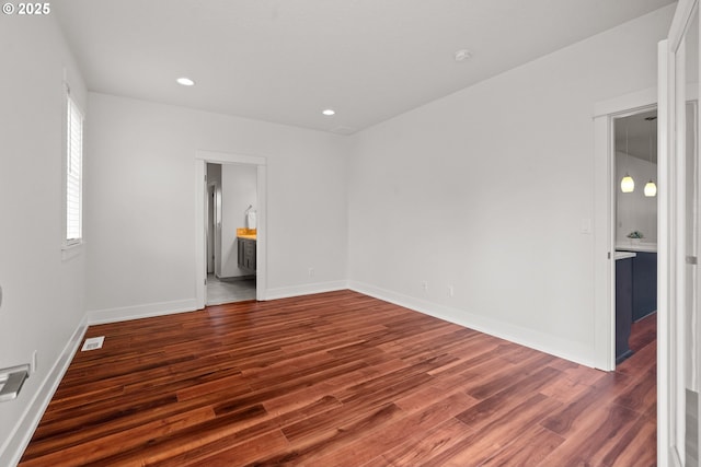 427 NW Garibaldi St, Hillsboro, OR 97124 - empty room with wood finished floors, baseboards, and recessed lighting