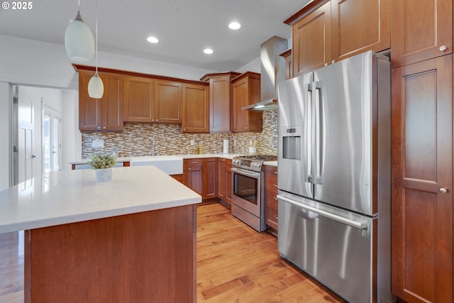 427 NW Garibaldi St, Hillsboro, OR 97124 - kitchen featuring appliances with stainless steel finishes, a sink, wall chimney exhaust hood, brown cabinetry, and decorative backsplash