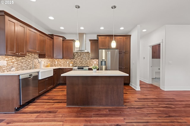 427 NW Garibaldi St, Hillsboro, OR 97124 - kitchen with wall chimney range hood, stainless steel appliances, light countertops, decorative backsplash, and recessed lighting