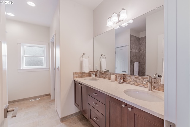 427 NW Garibaldi St, Hillsboro, OR 97124 - bathroom with double vanity, walk in shower, baseboards, tasteful backsplash, and recessed lighting