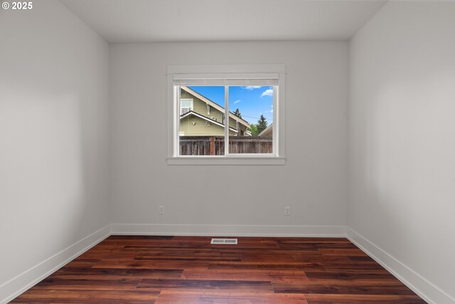 427 NW Garibaldi St, Hillsboro, OR 97124 - spare room featuring wood finished floors and baseboards