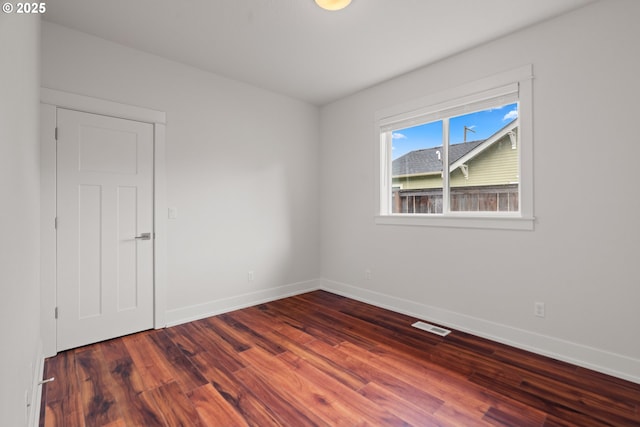 427 NW Garibaldi St, Hillsboro, OR 97124 - empty room featuring dark wood-style flooring and baseboards