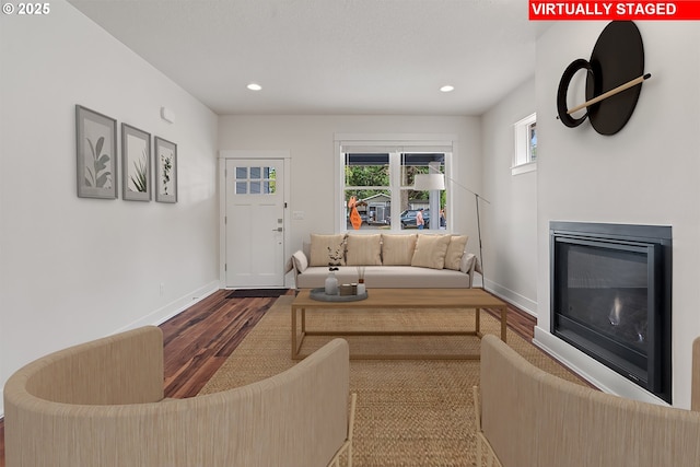 427 NW Garibaldi St, Hillsboro, OR 97124 - living area featuring wood finished floors, baseboards, a glass covered fireplace, and recessed lighting
