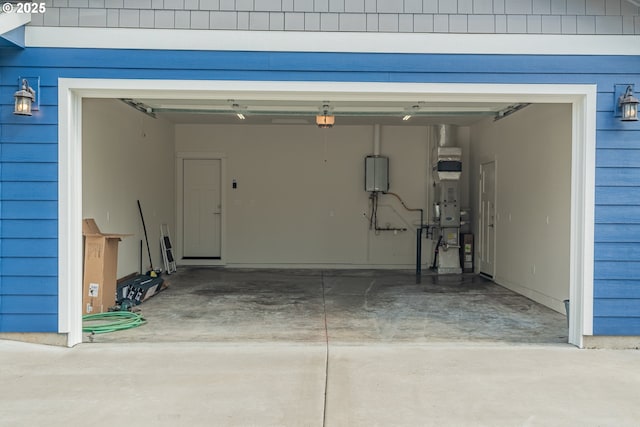 427 NW Garibaldi St, Hillsboro, OR 97124 - garage with concrete driveway, water heater, and a garage door opener