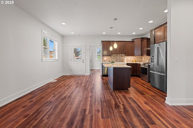 427 NW Garibaldi St, Hillsboro, OR 97124 - kitchen featuring stainless steel appliances, healthy amount of natural light, light countertops, dark wood-type flooring, and recessed lighting