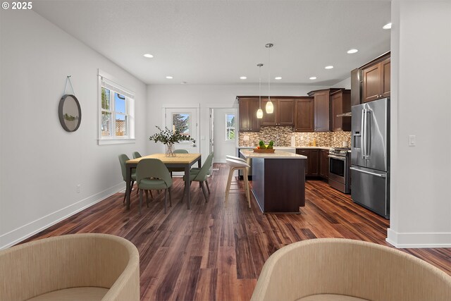 427 NW Garibaldi St, Hillsboro, OR 97124 - kitchen with appliances with stainless steel finishes, dark brown cabinets, a center island, light countertops, and recessed lighting