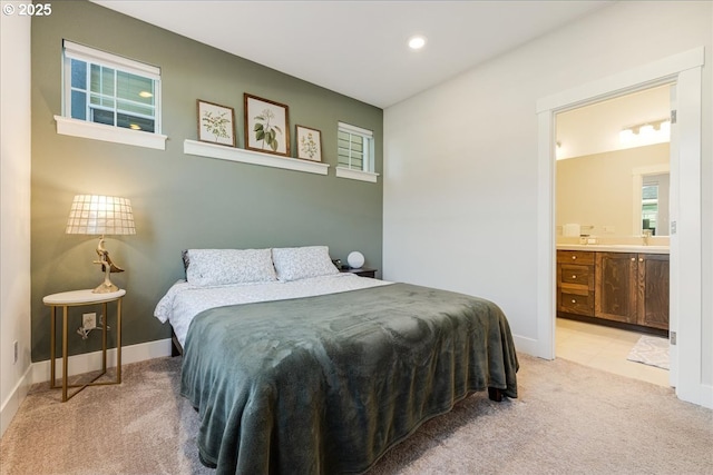 bedroom with light carpet, baseboards, connected bathroom, and recessed lighting