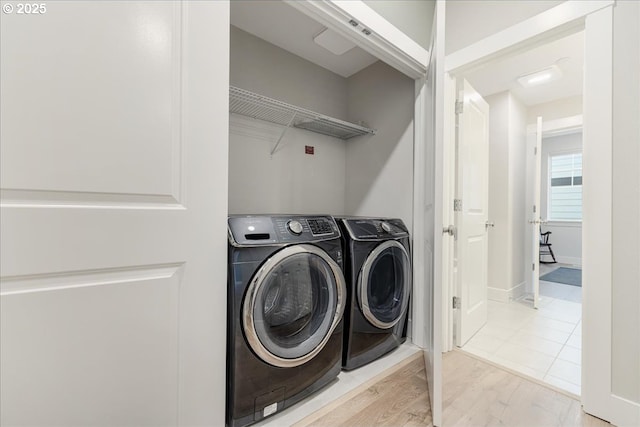 laundry room featuring laundry area, independent washer and dryer, and light wood-style flooring