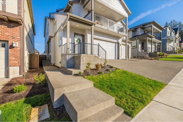 view of front of property featuring a garage, a residential view, and concrete driveway