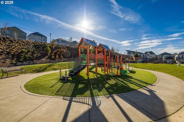 communal playground with a yard and a residential view