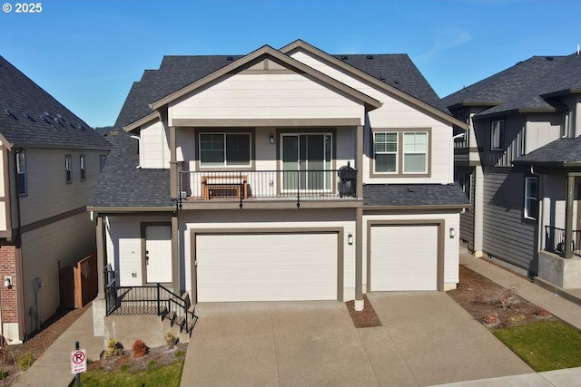 view of front of property with a garage, concrete driveway, roof with shingles, and a balcony