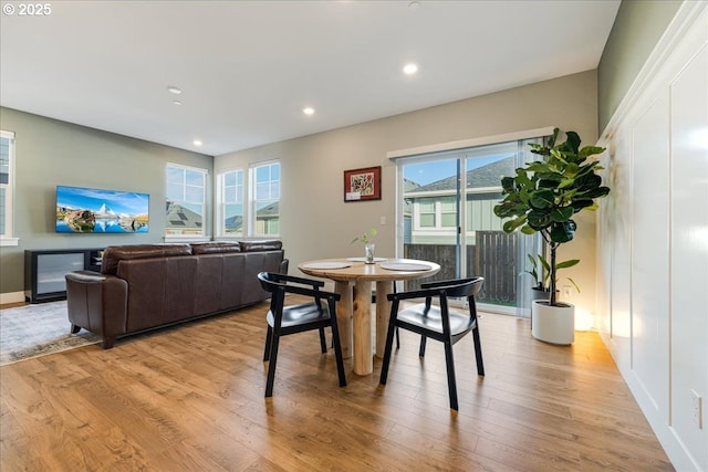 dining space with light wood-type flooring and recessed lighting