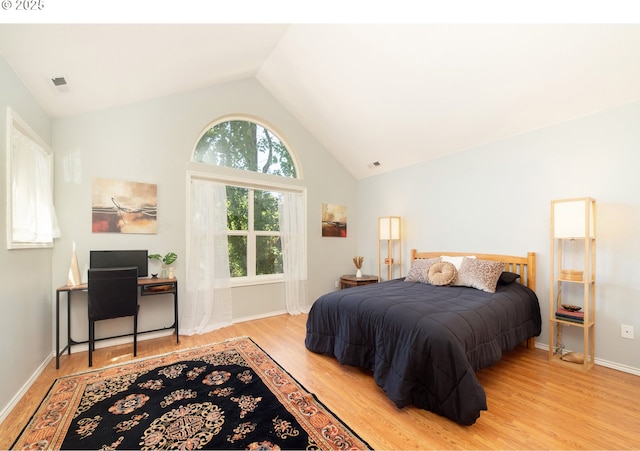 3540 S Corbett Ave, Portland, OR 97239 - bedroom featuring wood finished floors, high vaulted ceiling, and baseboards