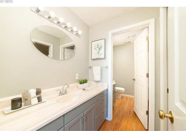 3540 S Corbett Ave, Portland, OR 97239 - bathroom featuring vanity, toilet, and wood finished floors