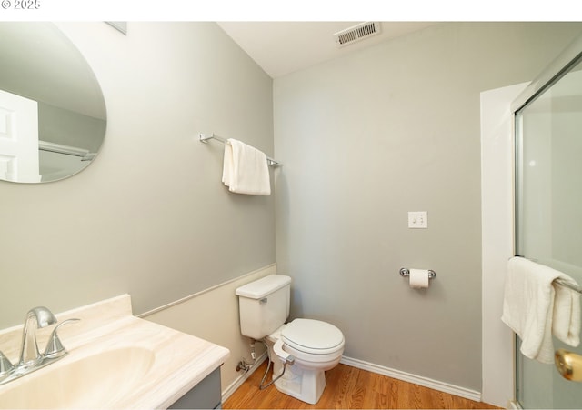 3540 S Corbett Ave, Portland, OR 97239 - full bathroom with wood finished floors, vanity, toilet, baseboards, and an enclosed shower