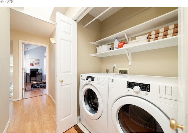 3540 S Corbett Ave, Portland, OR 97239 - washroom with washing machine and clothes dryer and light wood-type flooring