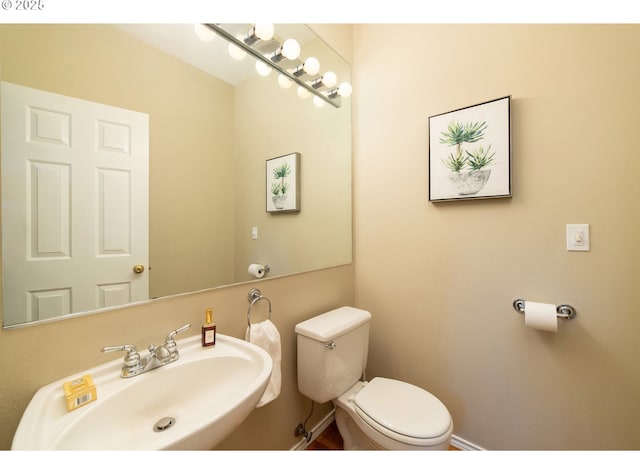 3540 S Corbett Ave, Portland, OR 97239 - bathroom with a sink, toilet, and baseboards