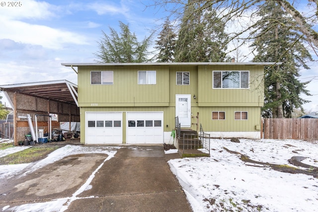 bi-level home with a carport and a garage