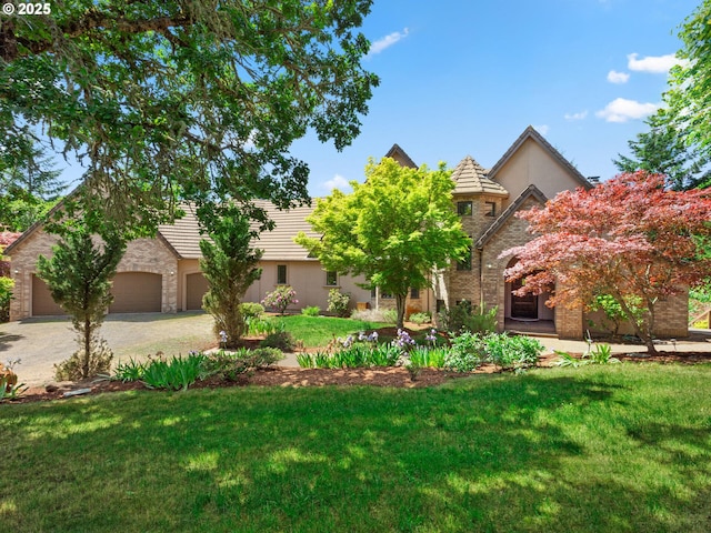 8801 SE Walnut Dr, Amity, OR 97101 - view of front of house featuring a front lawn, stone siding, a tiled roof, stucco siding, and driveway