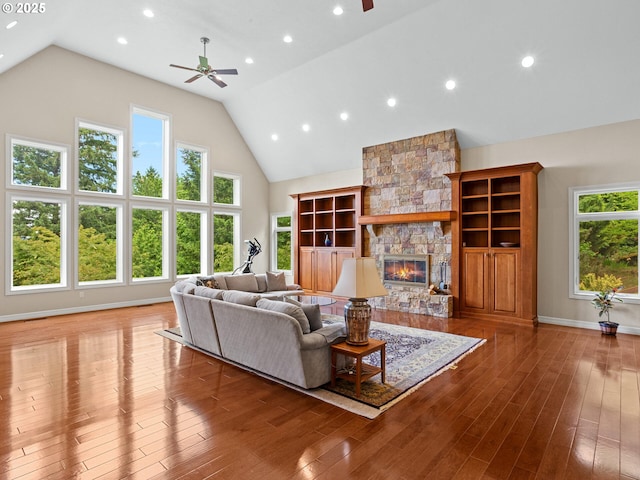 8801 SE Walnut Dr, Amity, OR 97101 - living area with ceiling fan, a stone fireplace, high vaulted ceiling, wood finished floors, and recessed lighting