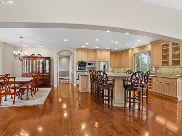 8801 SE Walnut Dr, Amity, OR 97101 - kitchen with stainless steel appliances, a sink, dark wood-style flooring, glass insert cabinets, and recessed lighting