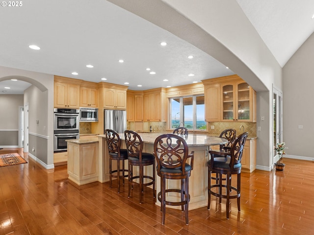 8801 SE Walnut Dr, Amity, OR 97101 - kitchen with appliances with stainless steel finishes, arched walkways, glass insert cabinets, recessed lighting, and light brown cabinetry