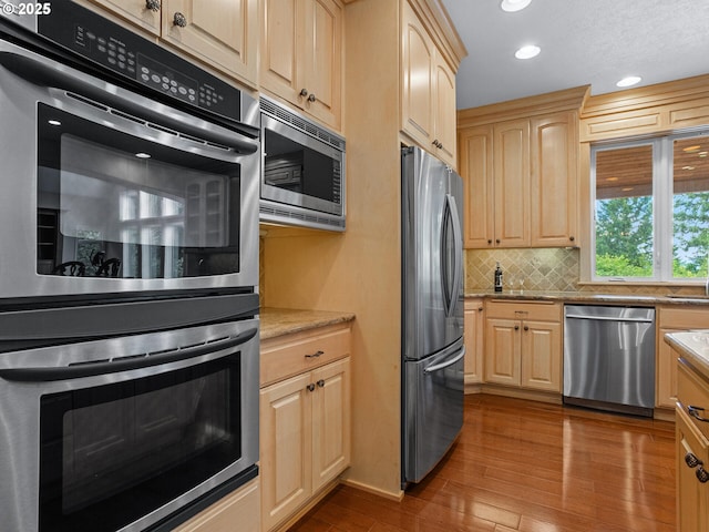8801 SE Walnut Dr, Amity, OR 97101 - kitchen with stainless steel appliances, light brown cabinetry, wood finished floors, and recessed lighting