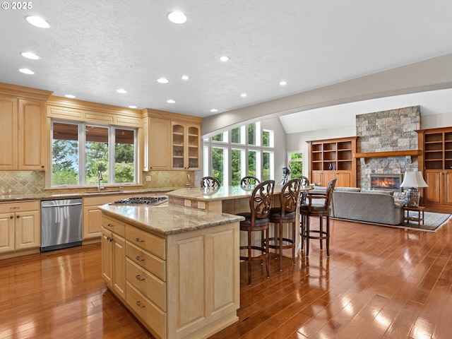 8801 SE Walnut Dr, Amity, OR 97101 - kitchen featuring appliances with stainless steel finishes, a kitchen island, a sink, light brown cabinetry, and recessed lighting