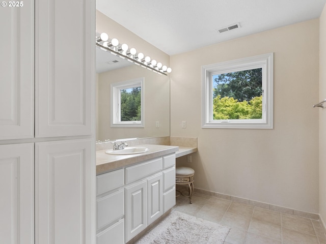 8801 SE Walnut Dr, Amity, OR 97101 - bathroom featuring vanity, healthy amount of natural light, baseboards, and tile patterned floors