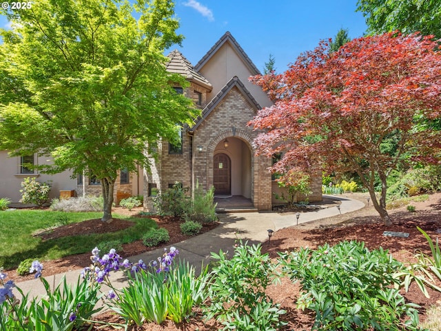 8801 SE Walnut Dr, Amity, OR 97101 - tudor house featuring stucco siding, brick siding, and a tiled roof
