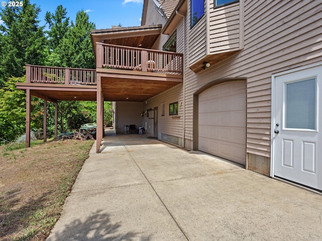 8801 SE Walnut Dr, Amity, OR 97101 - view of property exterior featuring a garage, a deck, and concrete driveway