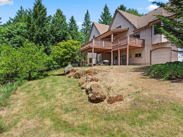 8801 SE Walnut Dr, Amity, OR 97101 - rear view of property with a deck, a lawn, and an attached garage