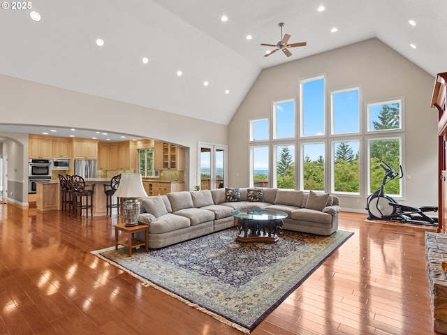 8801 SE Walnut Dr, Amity, OR 97101 - living area with high vaulted ceiling, arched walkways, ceiling fan, light wood-type flooring, and recessed lighting