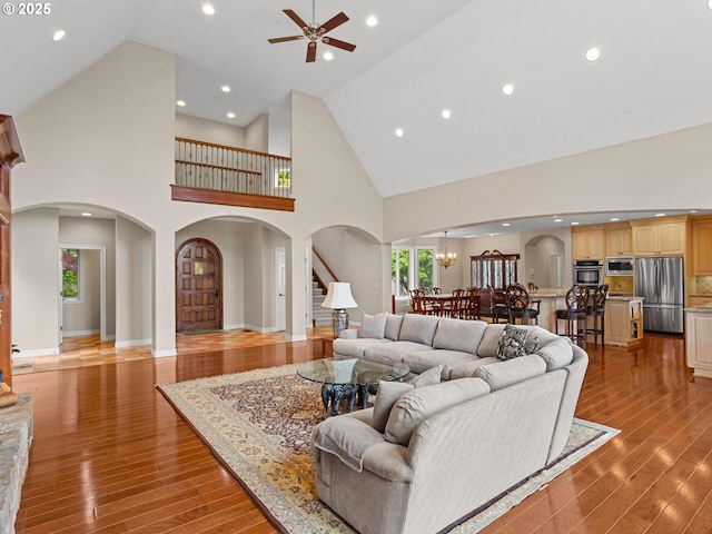 8801 SE Walnut Dr, Amity, OR 97101 - living room with high vaulted ceiling, ceiling fan, arched walkways, light wood-type flooring, and recessed lighting
