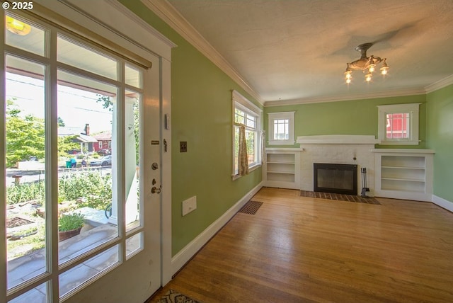 6115 SE 19th Ave, Portland, OR 97202 - unfurnished living room featuring wood finished floors, ornamental molding, a fireplace, and a chandelier