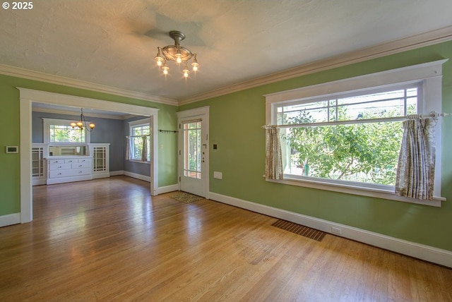 6115 SE 19th Ave, Portland, OR 97202 - empty room with a chandelier, wood finished floors, plenty of natural light, and crown molding