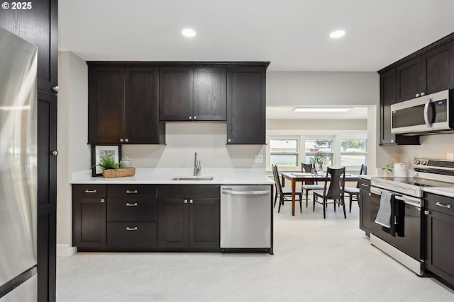 900 H St, The Dalles, OR 97058 - kitchen featuring appliances with stainless steel finishes, light countertops, recessed lighting, and dark brown cabinets