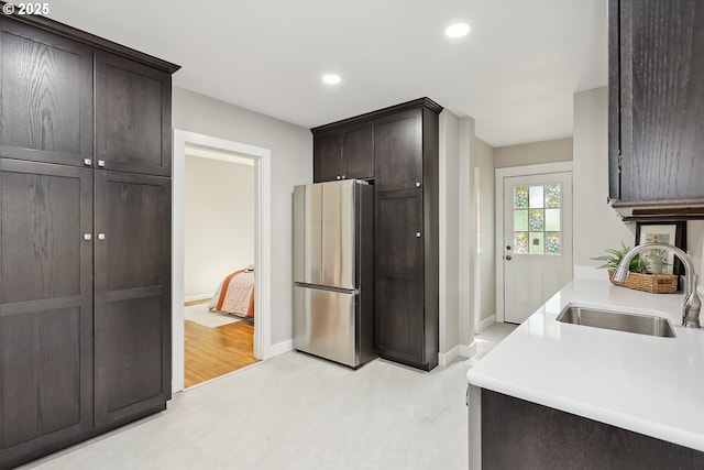 900 H St, The Dalles, OR 97058 - kitchen featuring freestanding refrigerator, dark brown cabinets, recessed lighting, and light countertops