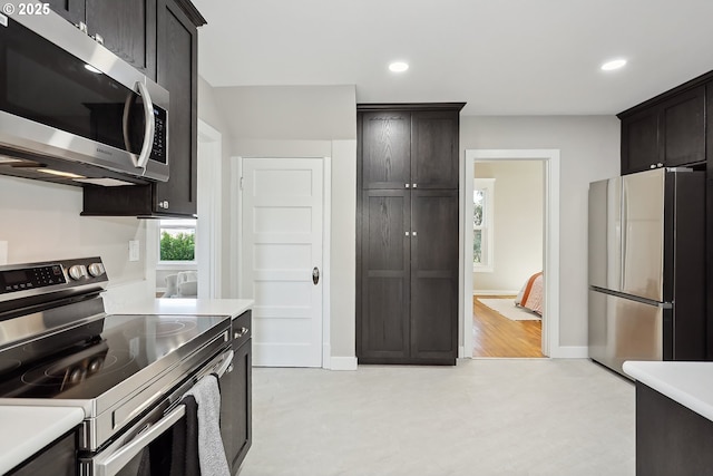 900 H St, The Dalles, OR 97058 - kitchen with stainless steel appliances, light countertops, recessed lighting, and dark brown cabinetry