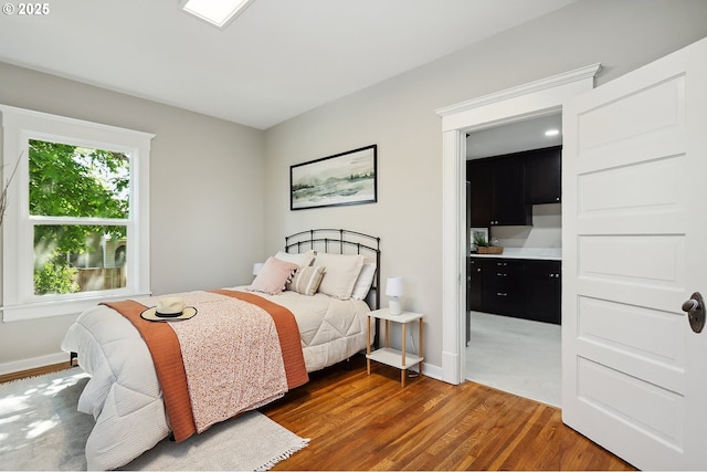 900 H St, The Dalles, OR 97058 - bedroom with wood finished floors and connected bathroom