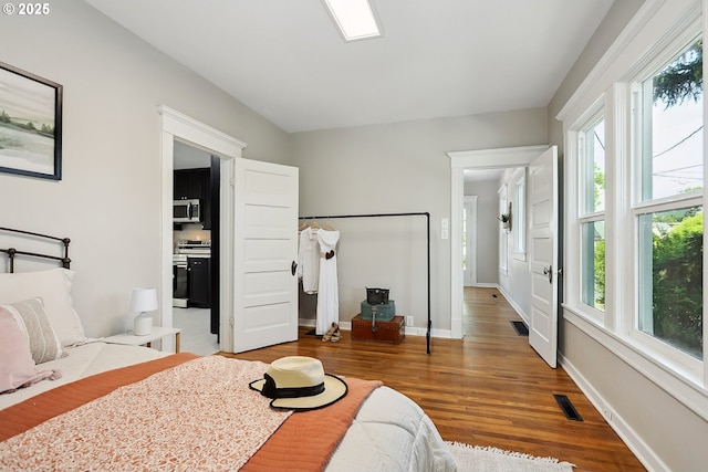 900 H St, The Dalles, OR 97058 - bedroom featuring multiple windows and wood finished floors