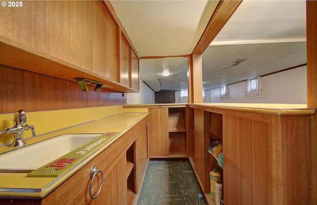 bar with a sink and dark floors