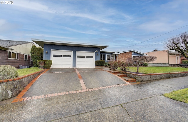 view of front of house with a front lawn, an attached garage, and driveway