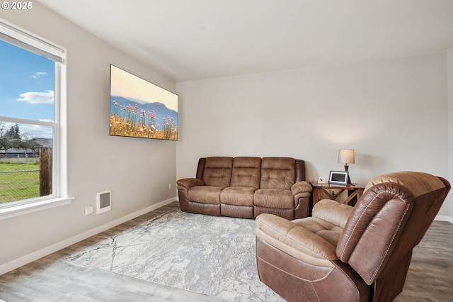 living room featuring baseboards and wood finished floors